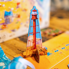 Load image into Gallery viewer, 3D lighthouse model on a colorful surface with a blurred background