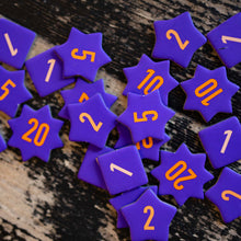 Load image into Gallery viewer, Purple star-shaped dice with numbers on a wooden surface