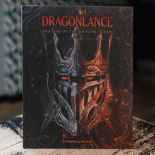 Load image into Gallery viewer, Dragonlance: Shadow of the Dragon Queen boxed set or book standing upright on a rustic wooden surface, with a dark fantasy illustration of a split silver and orange helmet on the cover.