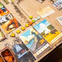 Load image into Gallery viewer, Educational puzzle with cards featuring national parks on a wooden surface
