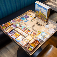 Load image into Gallery viewer, Board game with cards and pieces on a table, featuring the 'Parks' game box.
