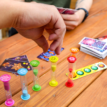 Load image into Gallery viewer, Someone's hand is about to pick up a sand timer.
