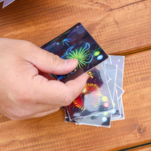 Load image into Gallery viewer, A hand picking up a card from the game.
