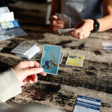 Load image into Gallery viewer, Person holding a card with a colorful design.
